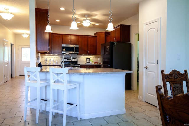 224 Aqueduct Cir, West Lafayette, IN 47906 - kitchen featuring appliances with stainless steel finishes, decorative backsplash, light tile patterned flooring, recessed lighting, and decorative light fixtures