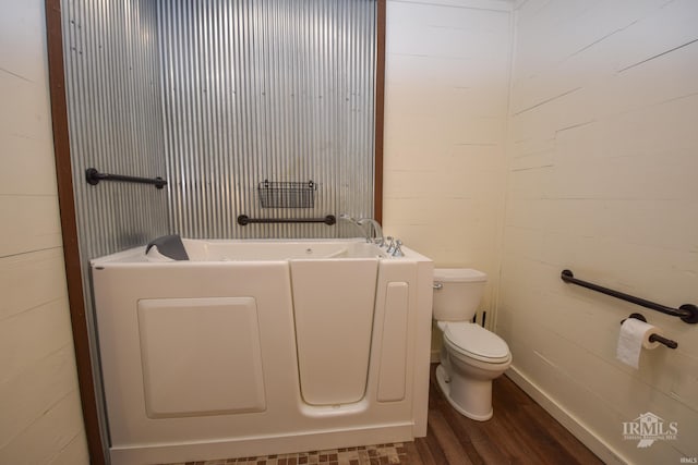 1809 E Royerton Rd, Muncie, IN 47303 - bathroom with wood finished floors, toilet, and a tub