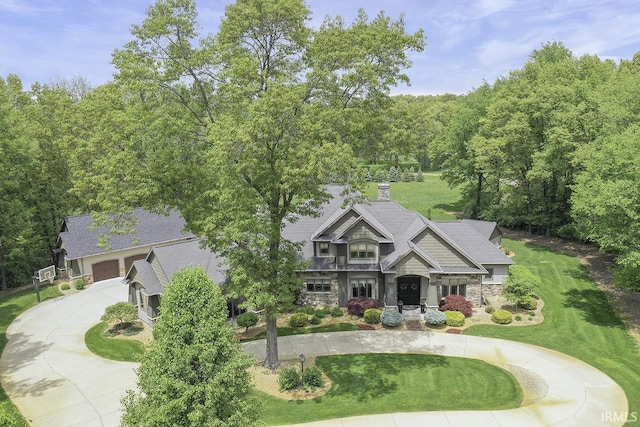 19861 County Road 16, Bristol, IN 46507 - view of front of house featuring curved driveway, stone siding, a chimney, and a front lawn