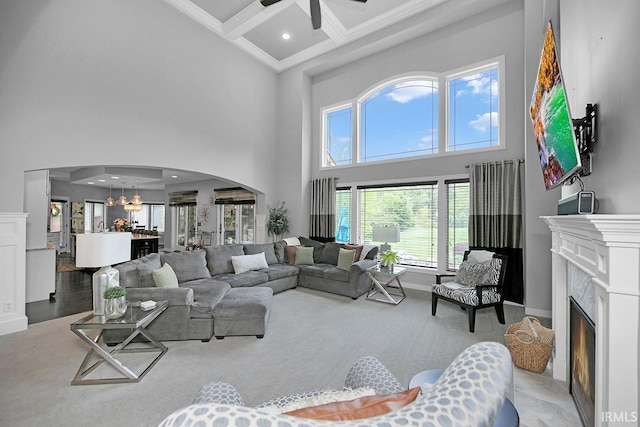 19861 County Road 16, Bristol, IN 46507 - carpeted living room featuring a high ceiling, arched walkways, a chandelier, coffered ceiling, and baseboards