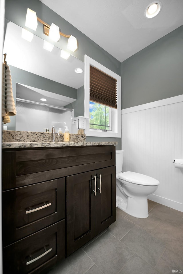 19861 County Road 16, Bristol, IN 46507 - bathroom featuring wainscoting, toilet, vanity, and tile patterned floors