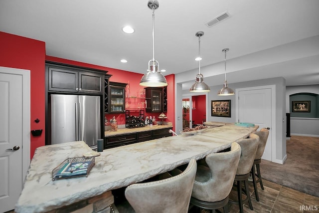 19861 County Road 16, Bristol, IN 46507 - kitchen featuring freestanding refrigerator, a kitchen breakfast bar, recessed lighting, glass insert cabinets, and pendant lighting