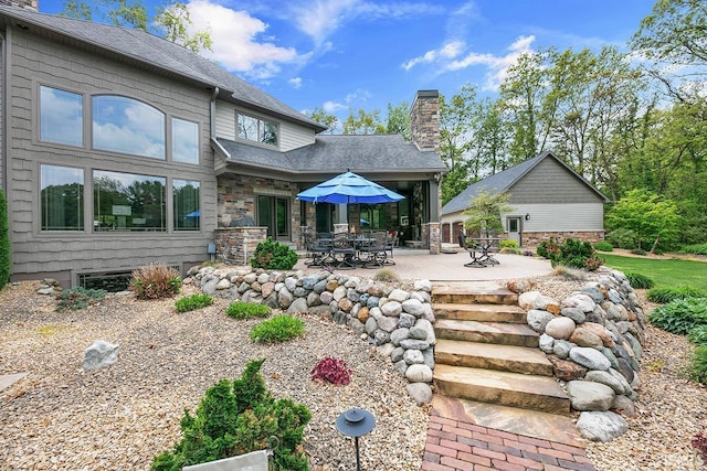 19861 County Road 16, Bristol, IN 46507 - back of property featuring a chimney, a patio area, and roof with shingles