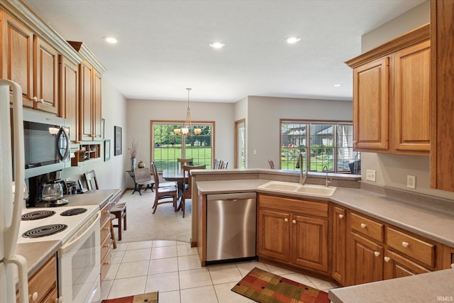 1916 Greenwood Dr, Goshen, IN 46526 - kitchen featuring appliances with stainless steel finishes, a sink, plenty of natural light, recessed lighting, and light colored carpet