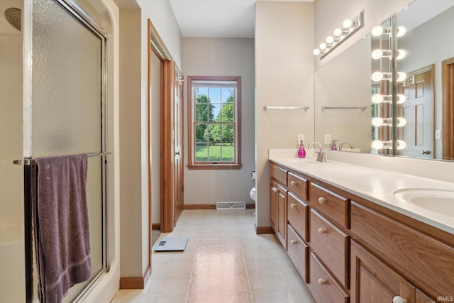 1916 Greenwood Dr, Goshen, IN 46526 - bathroom with baseboards, a stall shower, double vanity, toilet, and tile patterned flooring