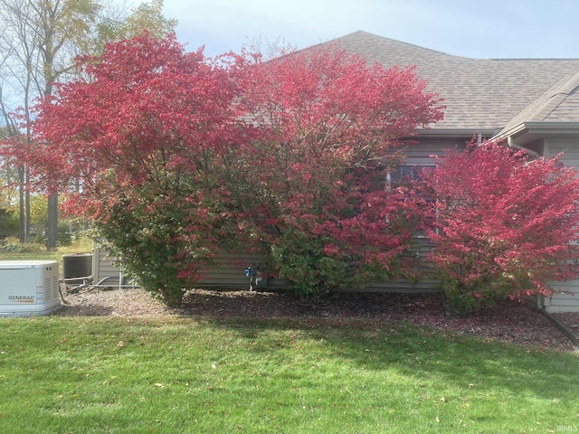 1916 Greenwood Dr, Goshen, IN 46526 - view of side of property featuring a lawn, roof with shingles, and central AC unit