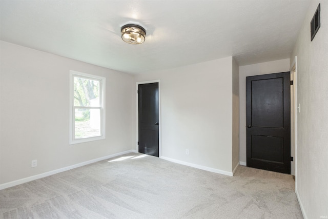 121 Palau St, Mishawaka, IN 46545 - spare room featuring light carpet and baseboards
