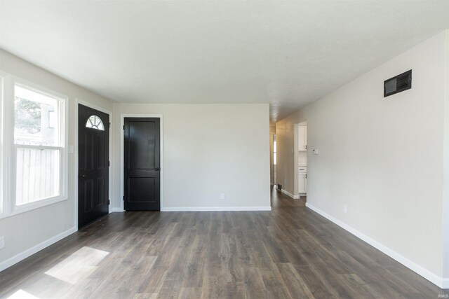 121 Palau St, Mishawaka, IN 46545 - unfurnished living room featuring dark wood-style flooring and baseboards