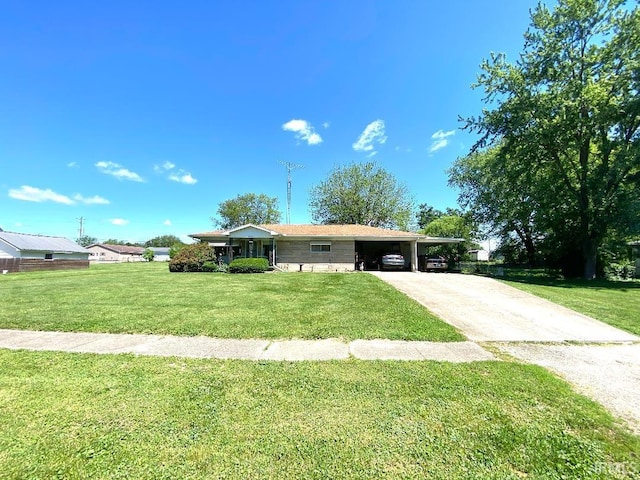 260 W Prairie St, Lyons, IN 47443 - ranch-style house featuring concrete driveway, a front yard, and an attached carport