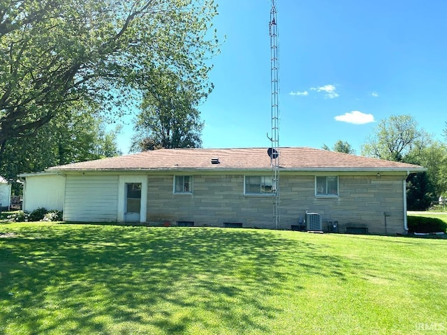 260 W Prairie St, Lyons, IN 47443 - back of property with stone siding, a yard, and central AC