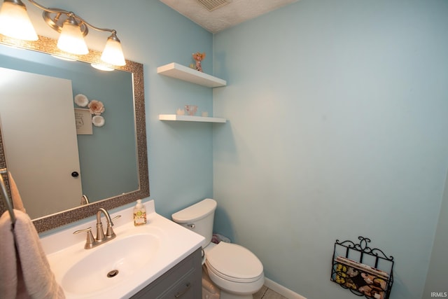 half bathroom featuring toilet, vanity, and tile patterned flooring