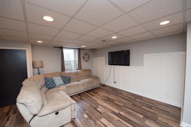 living room featuring wood finished floors, recessed lighting, and a drop ceiling