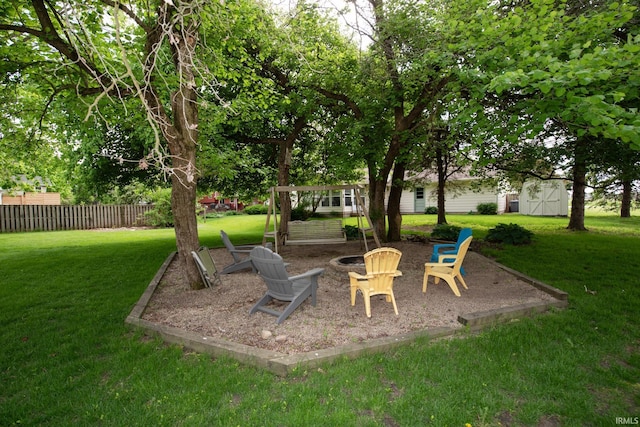 view of yard with an outdoor fire pit and an outbuilding