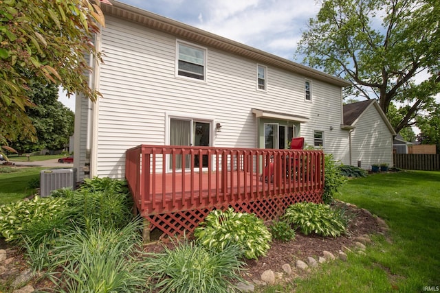 back of property featuring central air condition unit, a deck, and a yard