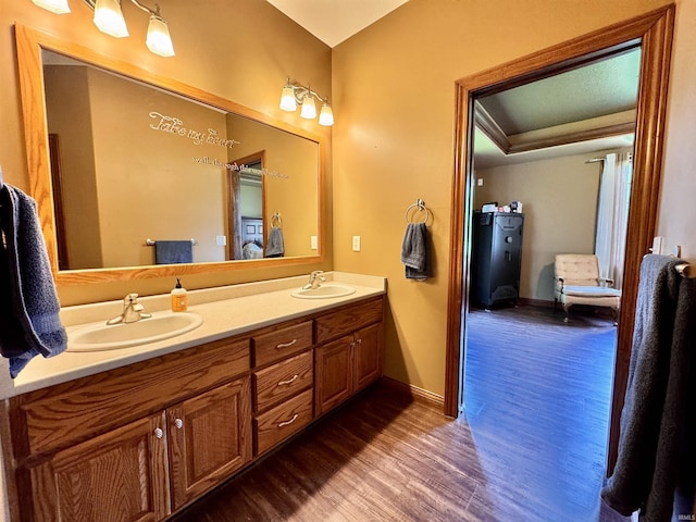 5936 County Road 427, Auburn, IN 46706 - bathroom with connected bathroom, wood finished floors, double vanity, and baseboards