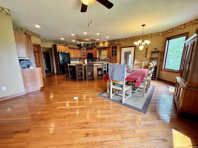 5936 County Road 427, Auburn, IN 46706 - dining area with a chandelier, light wood-type flooring, baseboards, a textured ceiling, and ceiling fan