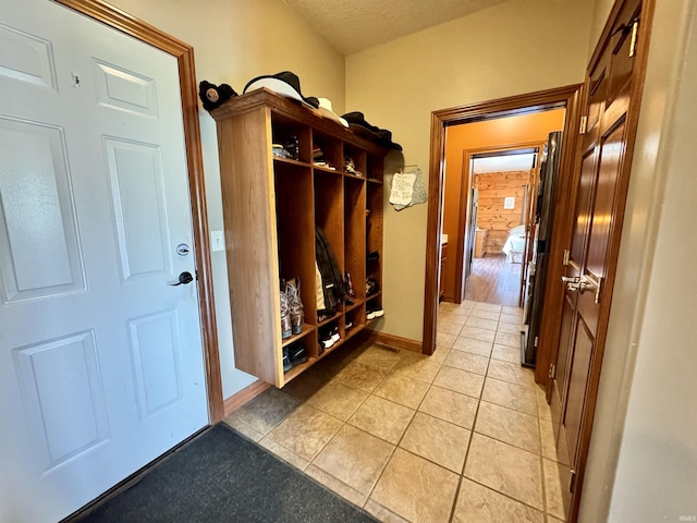 5936 County Road 427, Auburn, IN 46706 - mudroom featuring light tile patterned floors, a textured ceiling, and baseboards