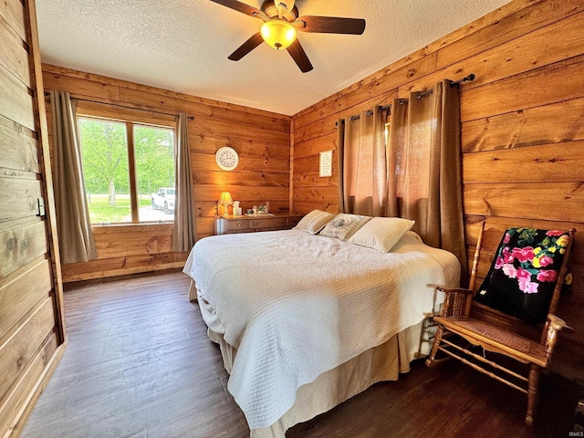 5936 County Road 427, Auburn, IN 46706 - bedroom featuring a textured ceiling, wood finished floors, wooden walls, and a ceiling fan
