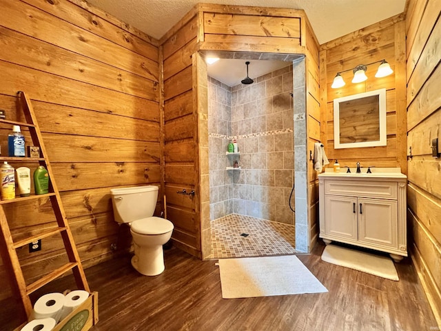 5936 County Road 427, Auburn, IN 46706 - full bath featuring wood finished floors, toilet, a walk in shower, wooden walls, and vanity