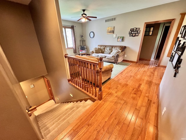 5936 County Road 427, Auburn, IN 46706 - living area with a ceiling fan, light wood-style floors, and baseboards