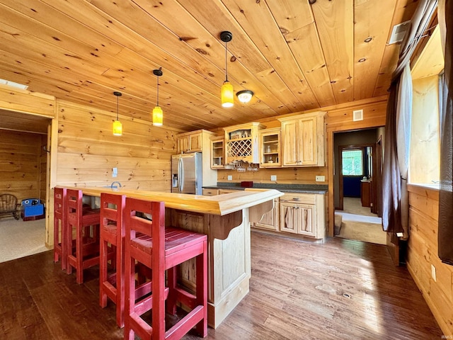 5936 County Road 427, Auburn, IN 46706 - kitchen with stainless steel fridge with ice dispenser, wood walls, wood ceiling, dark wood-type flooring, and glass insert cabinets