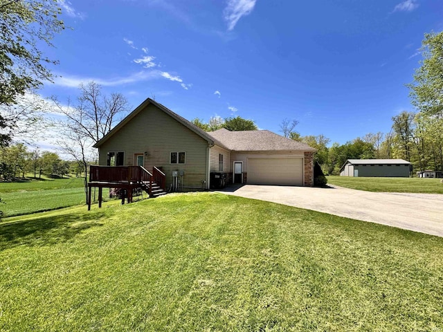 5936 County Road 427, Auburn, IN 46706 - view of front of home featuring driveway, an attached garage, a front lawn, and a wooden deck
