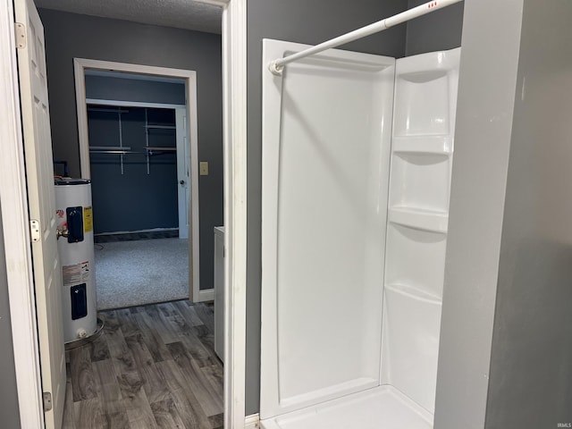 5861 Jordan Village Rd, Poland, IN 47868 - bathroom featuring water heater, a stall shower, and wood finished floors