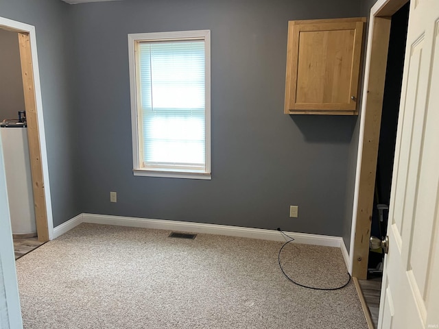 5861 Jordan Village Rd, Poland, IN 47868 - spare room featuring carpet flooring, baseboards, and water heater