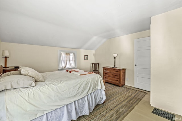 bedroom featuring vaulted ceiling and wood finished floors
