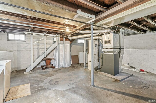 below grade area featuring washer and dryer and heating unit