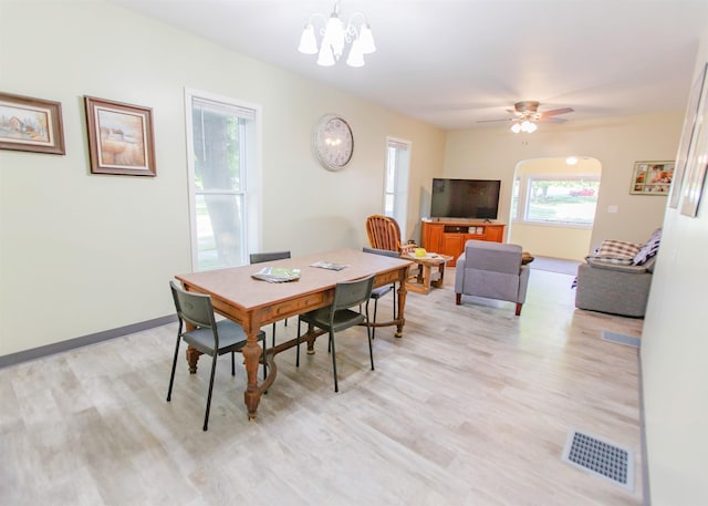 201 N Gonser Ave, Ashley, IN 46705 - dining space with light wood-style flooring, a chandelier, and arched walkways
