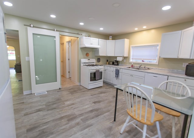 201 N Gonser Ave, Ashley, IN 46705 - kitchen with white appliances, a sink, light wood-type flooring, white cabinetry, and recessed lighting