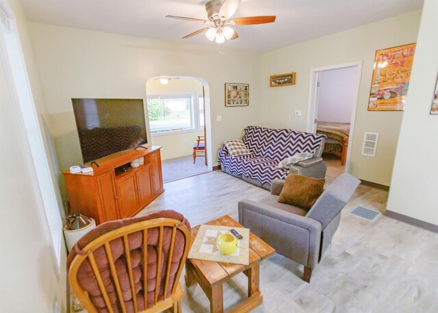 201 N Gonser Ave, Ashley, IN 46705 - living room featuring ceiling fan, arched walkways, and light wood-style floors