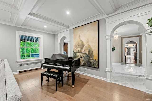 sitting room featuring ornate columns, arched walkways, wood finished floors, recessed lighting, and beamed ceiling