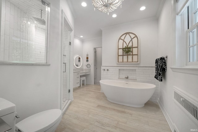 bathroom featuring radiator, crown molding, a shower stall, toilet, and a soaking tub