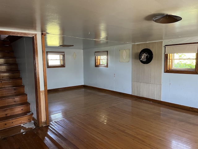 8350 S 850 Rd W, South Whitley, IN 46787 - empty room featuring wood-type flooring, stairs, plenty of natural light, and baseboards