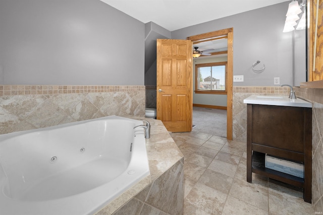845 N Wayne St, Waterloo, IN 46793 - bathroom featuring vanity, a ceiling fan, a whirlpool tub, tile walls, and toilet