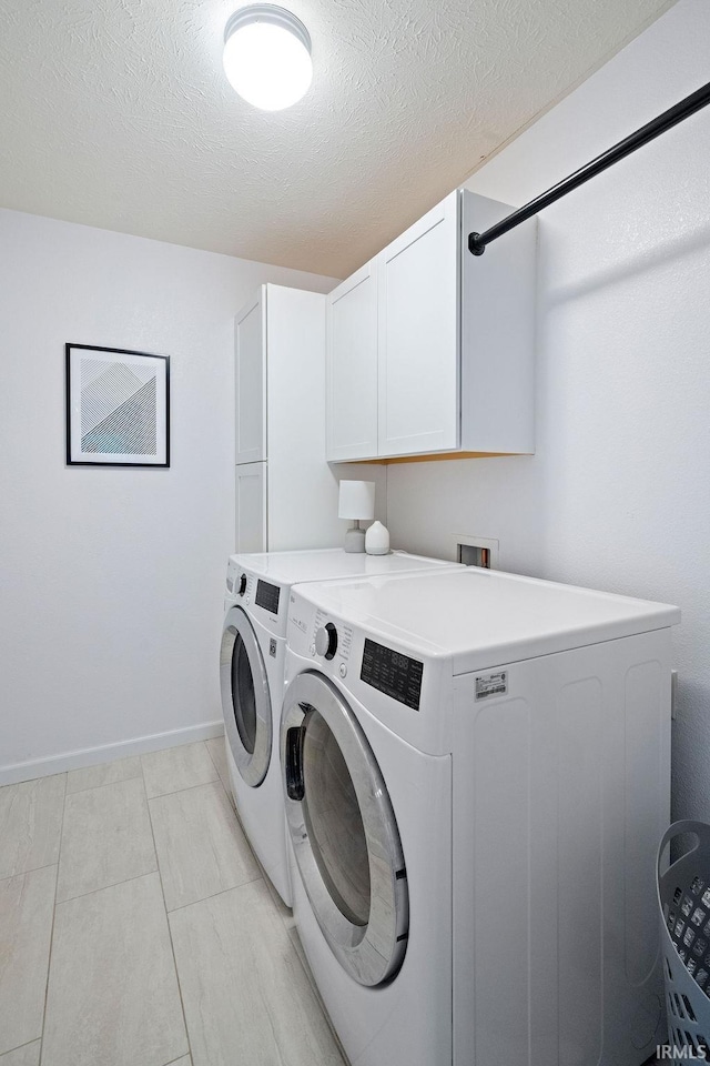 3154 Sand Walk Dr, Kokomo, IN 46902 - laundry room with cabinet space, washing machine and dryer, baseboards, and a textured ceiling