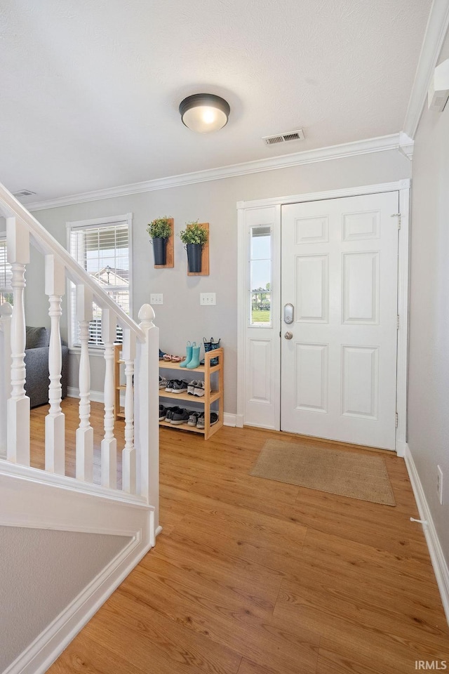 3154 Sand Walk Dr, Kokomo, IN 46902 - entryway with crown molding, light wood finished floors, baseboards, and stairs