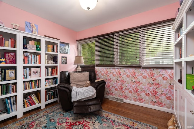 living area featuring baseboards and wood finished floors