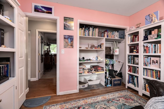 living area with wood finished floors and baseboards