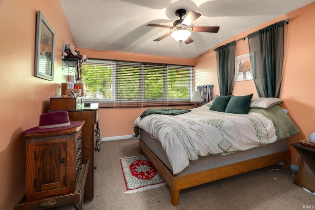 bedroom with carpet flooring, vaulted ceiling, and a ceiling fan