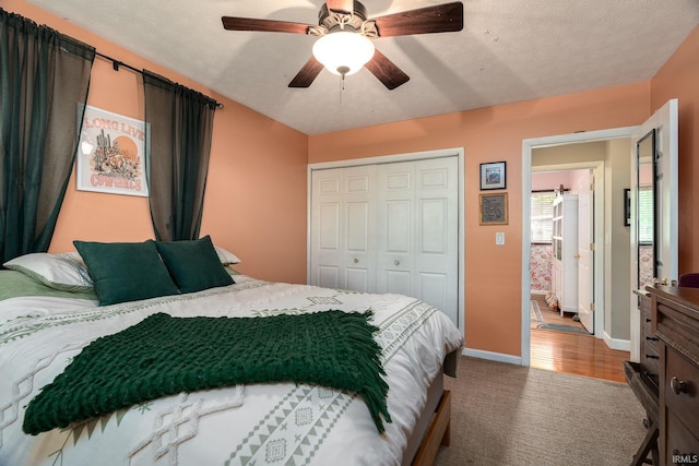 bedroom featuring a closet, carpet, baseboards, and a ceiling fan