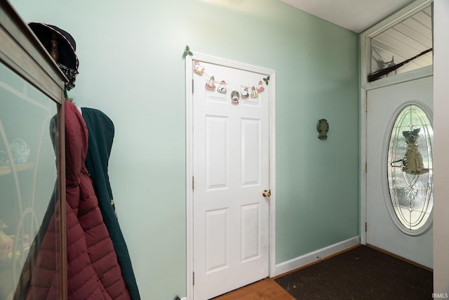 entryway featuring wood finished floors and baseboards