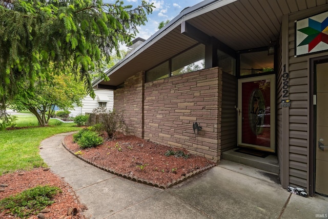 view of exterior entry featuring stone siding