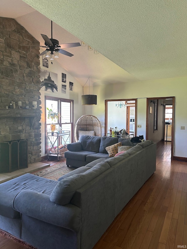 15560 Menominee Dr, Plymouth, IN 46563 - living area with a textured ceiling, lofted ceiling, a fireplace, hardwood / wood-style floors, and ceiling fan