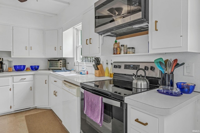 1500 El Prado St, Lafayette, IN 47905 - kitchen featuring appliances with stainless steel finishes, a sink, light countertops, and white cabinetry