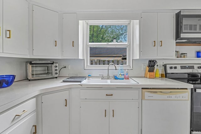 1500 El Prado St, Lafayette, IN 47905 - kitchen featuring appliances with stainless steel finishes, a sink, white cabinetry, and light countertops