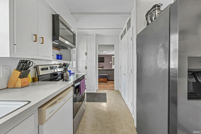 1500 El Prado St, Lafayette, IN 47905 - kitchen with stainless steel appliances, white cabinets, light countertops, light tile patterned flooring, and a sink