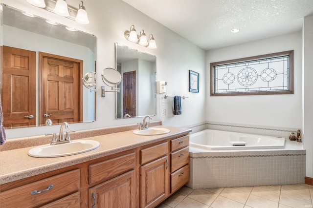 9725 Sea View Cv, Fort Wayne, IN 46835 - bathroom featuring a garden tub, tile patterned floors, double vanity, and a textured ceiling